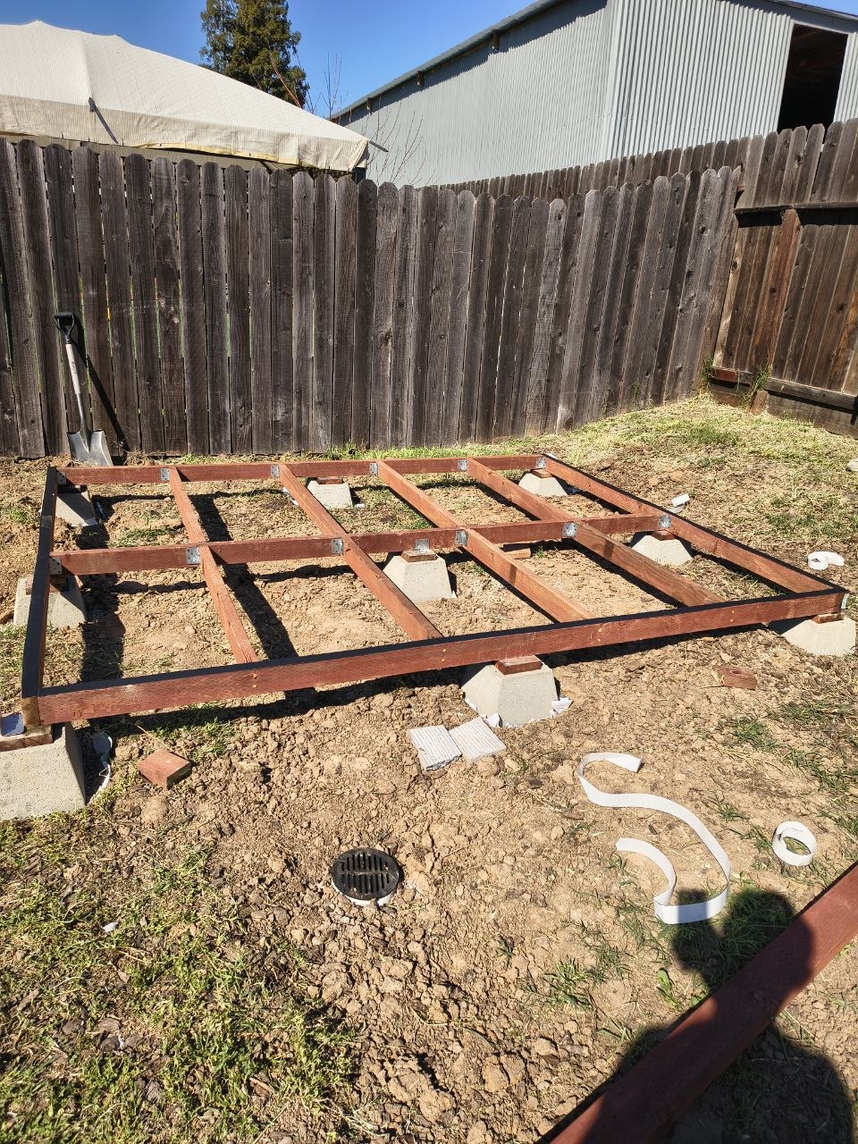 Unassembled shed kit parts laid out before build